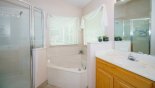 Master ensuite bathroom with Roman bath, walk-in shower, his & hers sinks & WC from Highlands Reserve rental Villa direct from owner
