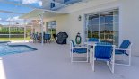 Pool deck with 2 patio tables and total of 12 chairs with this Orlando Villa for rent direct from owner