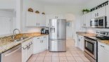 Spacious rental Highlands Reserve Villa in Orlando complete with stunning Kitchen viewed towards laundry room and games room beyond