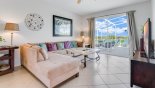 Spacious rental Highlands Reserve Villa in Orlando complete with stunning Family room for sectional sofa providing ample seating for all to watch TV - patio doors lead onto pool deck