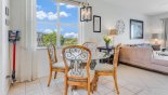 Breakfast nook with round glass topped table & 4 chairs with this Orlando Villa for rent direct from owner