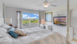 Villa rentals near Disney direct with owner, check out the Master bedroom #1 with large LED TV and views over the pool deck & golf course beyond