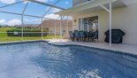 Covered lanai with patio table & 8 chairs - gas BBQ is a rental with this Orlando Villa for rent direct from owner
