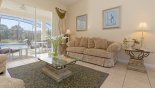 Villa rentals in Orlando, check out the Beautifully furnished living room with sliding door access to pool deck