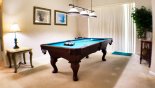 Games room equipped with a full-sized pool table - patio doors lead out to pool deck with this Orlando Villa for rent direct from owner