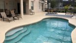 Pool deck with 4 sun loungers plus 2 patio tables with total of 12 chairs with this Orlando Villa for rent direct from owner