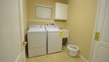 Villa rentals in Orlando, check out the Laundry room with washer, dryer, and soaking sink (iron & ironing board stored away in cupboard)
