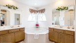 Master ensuite bathroom with corner bath & His & hers sinks - www.iwantavilla.com is the best in Orlando vacation Villa rentals