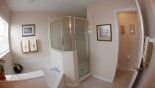 Spacious rental Highlands Reserve Villa in Orlando complete with stunning Ensuite bathroom showing large corner bath & walk-in shower
