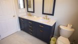 Family bathroom #3 with double sink modern vanity - www.iwantavilla.com is the best in Orlando vacation Villa rentals