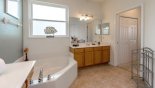 Master #1 ensuite bathroom with Roman bath, walk-in shower, dual vanities & separate WC with this Orlando Villa for rent direct from owner