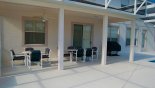 Covered porch with 2 patio tables and 10 chairs - great for alfresco dining - www.iwantavilla.com is your first choice of Villa rentals in Orlando direct with owner