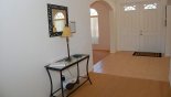 Entrance hallway viewed towards dining area through arch with this Orlando Villa for rent direct from owner