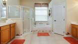 Villa rentals in Orlando, check out the Master 1 ensuite bathroom with Roman bath, his & hers sinks, large walk-in shower & separate WC