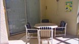 Covered lanai with patio table + 4 chairs with this Orlando Villa for rent direct from owner