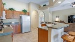 Dartmouth 2 Villa rental near Disney with View of kitchen and breakfast bar with 2 bar stools - arched opening leads to laundry room