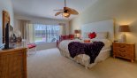Master bedroom with king size bed & views onto pool deck from Madison + 3 Villa for rent in Orlando
