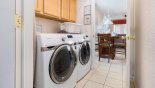 Laundry room off kitchen with quality front loading washer & dryer - www.iwantavilla.com is the best in Orlando vacation Villa rentals