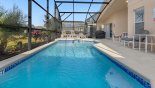 Spacious rental Emerald Island Resort Villa in Orlando complete with stunning Pool deck with seating and sun loungers. Covered Lanai with patio dining set and gas BBQ grill