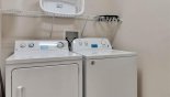Laundry room with washer, dryer, iron & ironing board - www.iwantavilla.com is the best in Orlando vacation Villa rentals