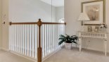 Upstairs landing overlooking the entrance foyer below with this Orlando Villa for rent direct from owner