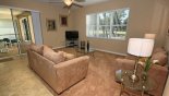 Family room with direct access and views onto pool deck with this Orlando Villa for rent direct from owner