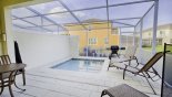 Spacious rental Serenity / Retreat Silver Creek Townhouse in Orlando complete with stunning Pool deck viewed from covered lanai showing BBQ