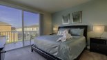 Master bedroom with king sized bed & private balcony - www.iwantavilla.com is the best in Orlando vacation Townhouse rentals