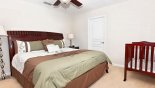 King bedroom #5 with crib - www.iwantavilla.com is your first choice of Villa rentals in Orlando direct with owner