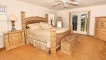 Master bedroom 1 with king sized bed & French doors leading onto full width balcony with this Orlando Villa for rent direct from owner