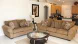 Family room with 2 sofas viewed towards kitchen with this Orlando Villa for rent direct from owner