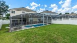 Rear of pool enclosure showing privacy fences to both sides - www.iwantavilla.com is the best in Orlando vacation Villa rentals