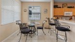 Breakfast nook adjacent to kitchen with seating for 4 and views onto pool deck with this Orlando Villa for rent direct from owner