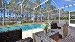 View of pool from stylish patio seating for 4 - www.iwantavilla.com is the best in Orlando vacation Villa rentals