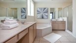 Master 1 ensuite bathroom with bath, walk-in shower. his & hers sinks & WC with this Orlando Villa for rent direct from owner