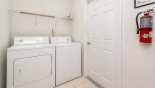 Laundry room with washer, dryer, iron & ironing board from Emerald + 5 Villa for rent in Orlando