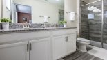 Master 2 ensuite bathroom with large walk-in shower, dual sinks & WC from Majesty Palm 4 Villa for rent in Orlando