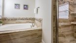 Master 1 ensuite with large Roman bath & double walk-in shower from Majesty Palm 5 Villa for rent in Orlando