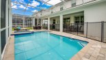 Pool viewed towards covered lanai - note pool safety fence erected with this Orlando Villa for rent direct from owner