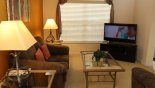 Living room off entrance foyer with large LCD cable TV - www.iwantavilla.com is the best in Orlando vacation Villa rentals