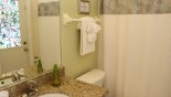 Master ensuite bathroom #2 with bath & shower over, single vanity & WC - also serves as pool bathroom with this Orlando Villa for rent direct from owner