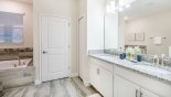 Master #1 ensuite bathroom with Roman bath, walk-in shower, his & hers sinks & separate WC with this Orlando Villa for rent direct from owner