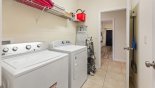 Spacious rental Ridgewood Lakes Villa in Orlando complete with stunning Laundry room with washer, dryer, iron & ironing board - doors leads to games room