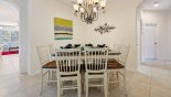 Dining room with large square table & 8 chairs - www.iwantavilla.com is the best in Orlando vacation Villa rentals