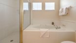 Shower & bath in Jack & Jill bathroom shared between bedroom 2 & 3 - www.iwantavilla.com is the best in Orlando vacation Condo rentals