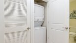 Laundry facility with compact washer / dryer stack - www.iwantavilla.com is the best in Orlando vacation Condo rentals