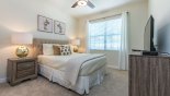 Ground floor Bedroom 5 with queen size bed, matching nightstands & ceiling fan from Alexander Palm 1 Villa for rent in Orlando