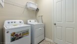 Laundry room with full sized washer & tumble dryer & iron & ironing board with this Orlando Villa for rent direct from owner