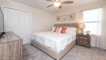 Bedroom 5 with king size bed, single nightstand with lamp & walk in wardrobe from Maui 8 Villa for rent in Orlando
