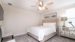 Villa rentals in Orlando, check out the Bedroom 7 with queen bed, ceiling fan & chest of drawers with lamp